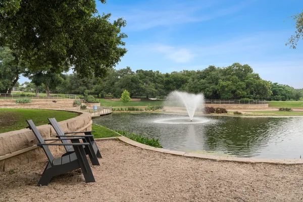 a view of a lake with a table and chairs