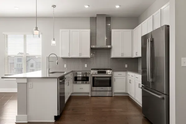 a view of a kitchen and a sink wooden floor