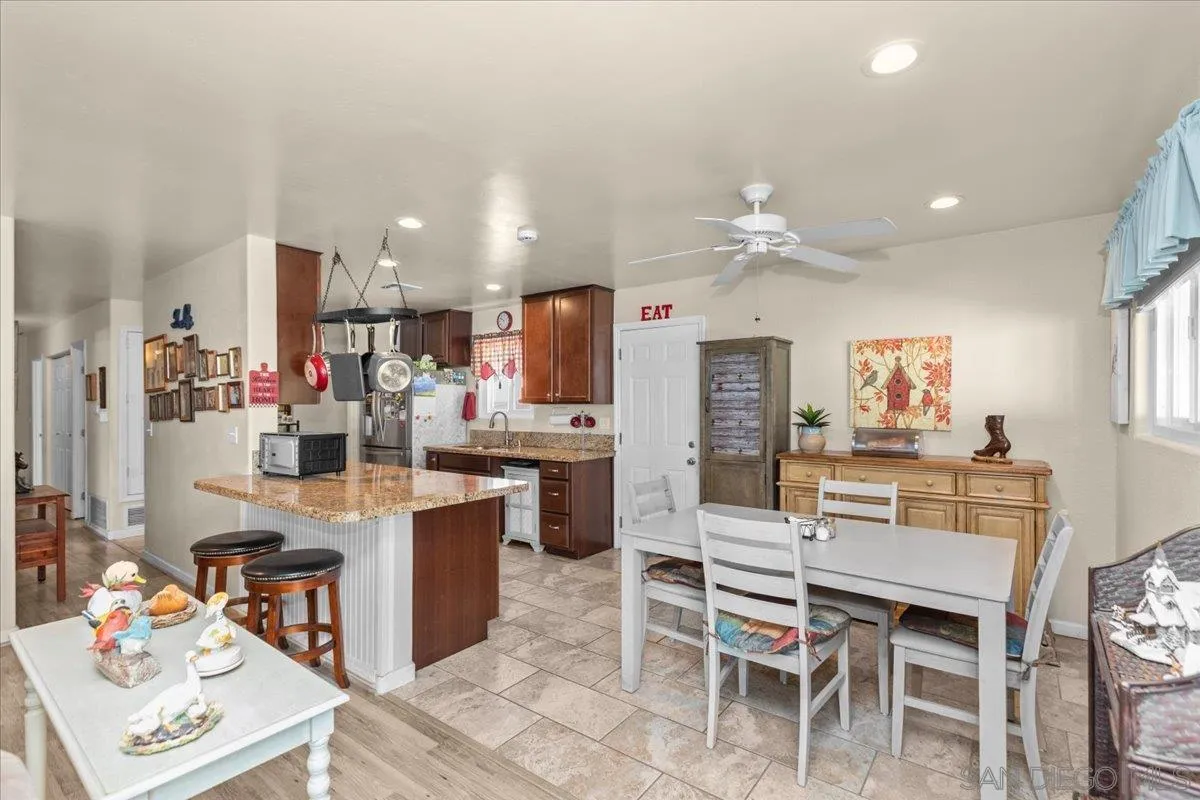 9254 Shadow Hill Road Santee, CA 92071 - Photo 9 of 34 a room with stainless steel appliances kitchen island granite countertop furniture and a view of kitchen