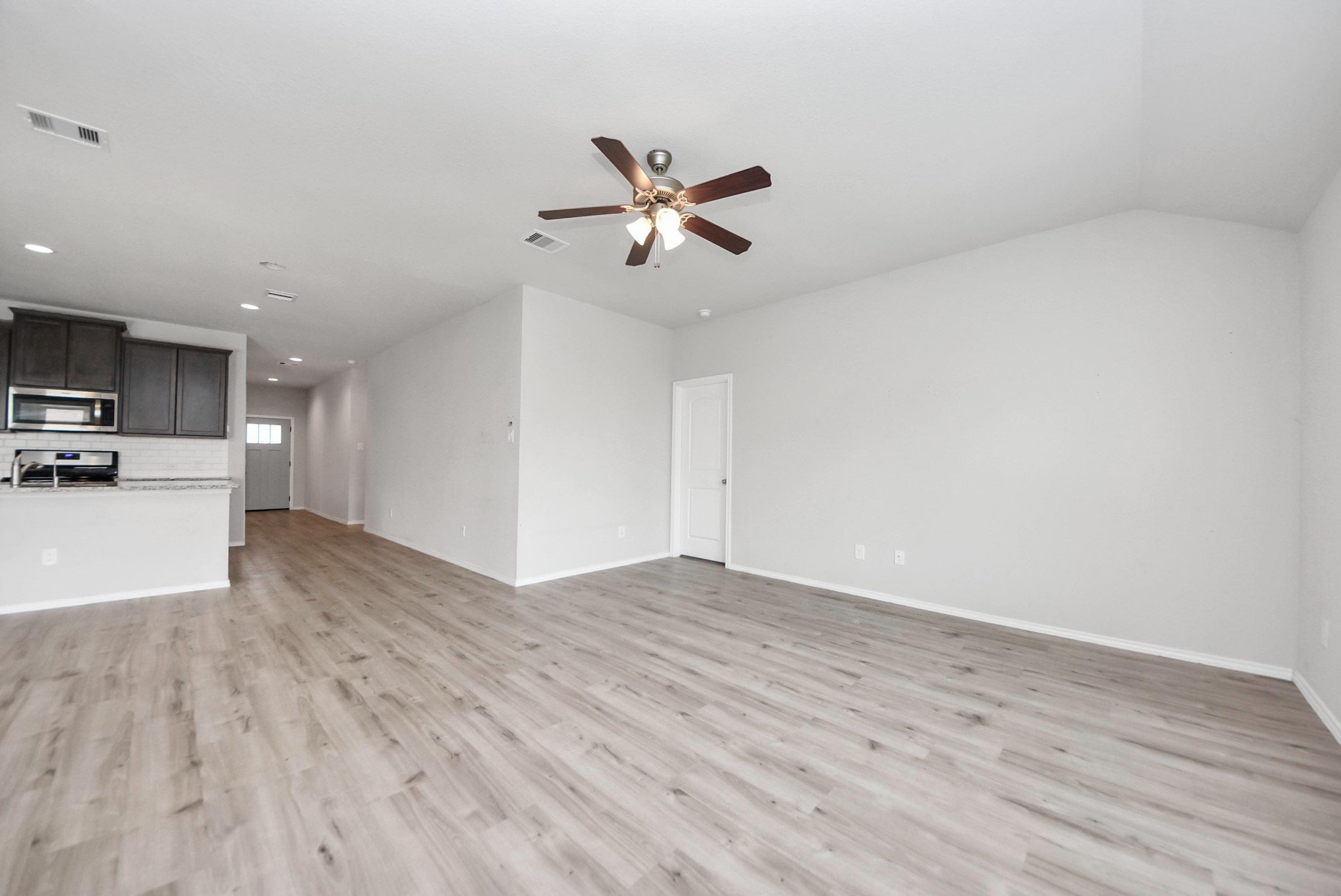 3305 Jagged Crow Lane Conroe, TX 77301 - Photo 12 of 30 a view of a kitchen with a dishwasher and wooden floor