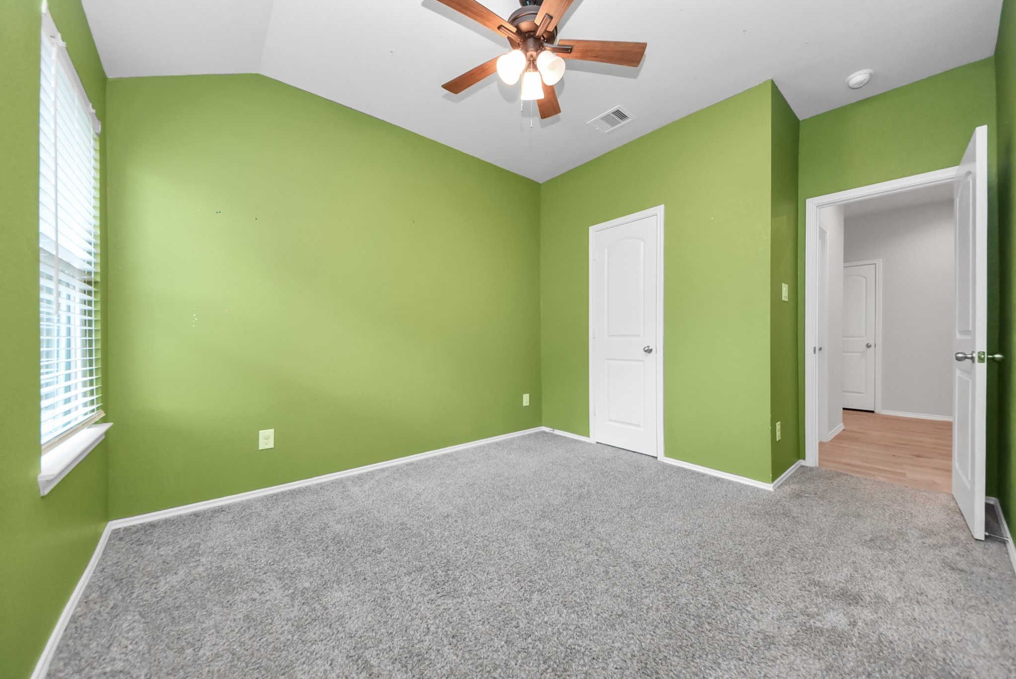 3305 Jagged Crow Lane Conroe, TX 77301 - Photo 25 of 30 a view of a big room with windows and chandelier fan