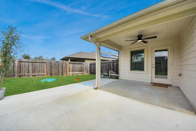 a view of a house with backyard and porch