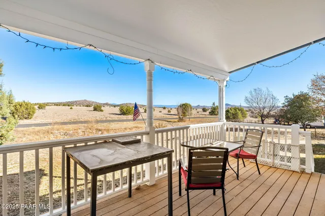 a view of a balcony with furniture