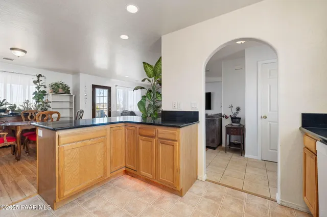 a kitchen with sink a refrigerator and couches