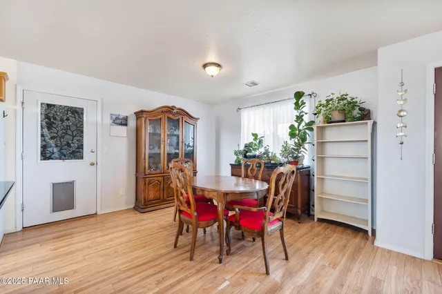 a view of a dining room with furniture window and wooden floor