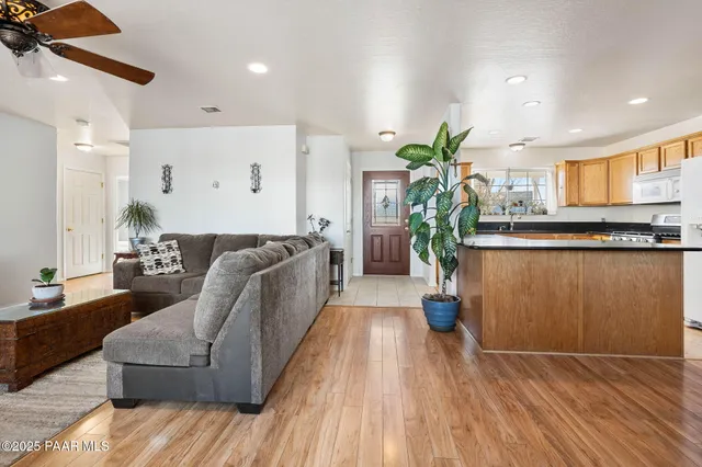 a living room with furniture and a potted plant