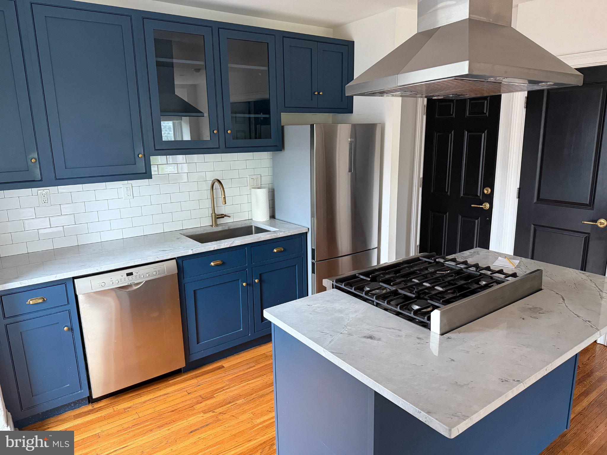 815 South 49th Street Philadelphia, PA 19143 - Photo 36 of 72 a kitchen with stainless steel appliances granite countertop a sink stove and refrigerator