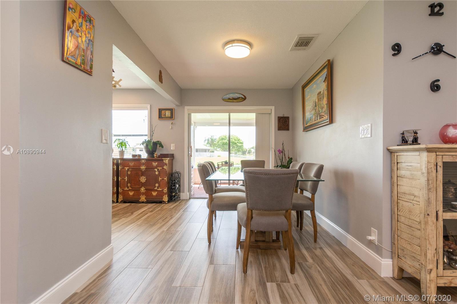 9254 Gettysburg Road Boca Raton, FL 33434 - Photo 11 of 49 a dining room with furniture and wooden floor