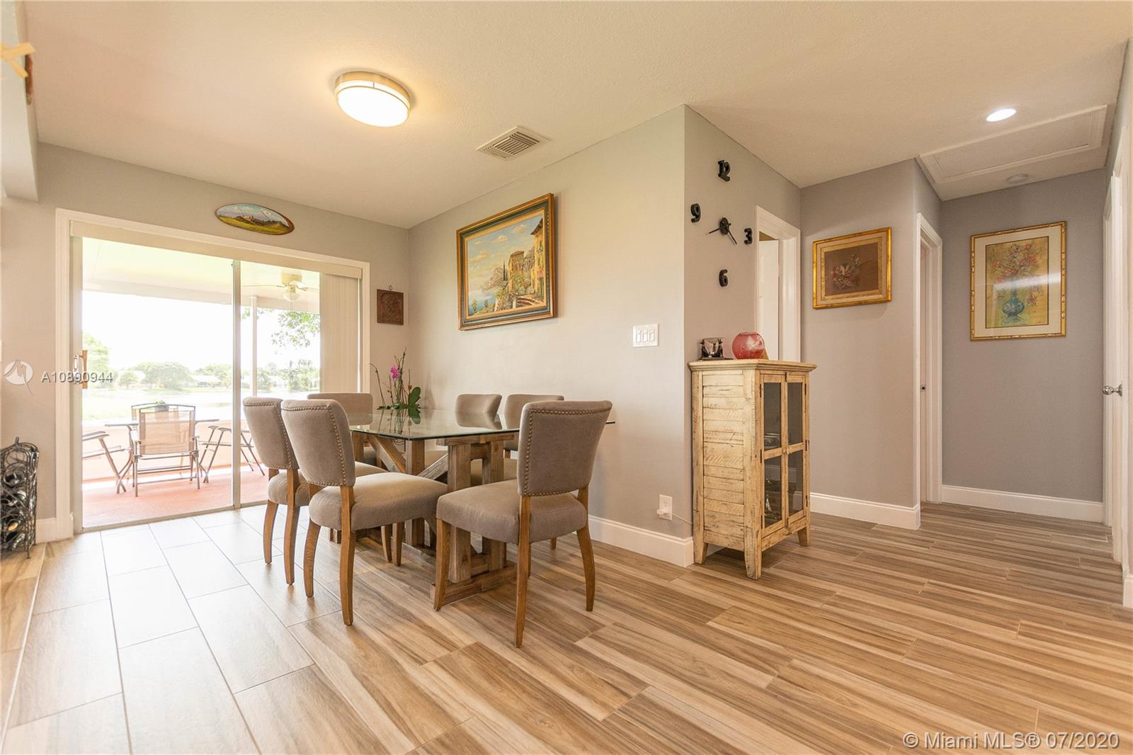 9254 Gettysburg Road Boca Raton, FL 33434 - Photo 12 of 49 a dining room with wooden floor and large window
