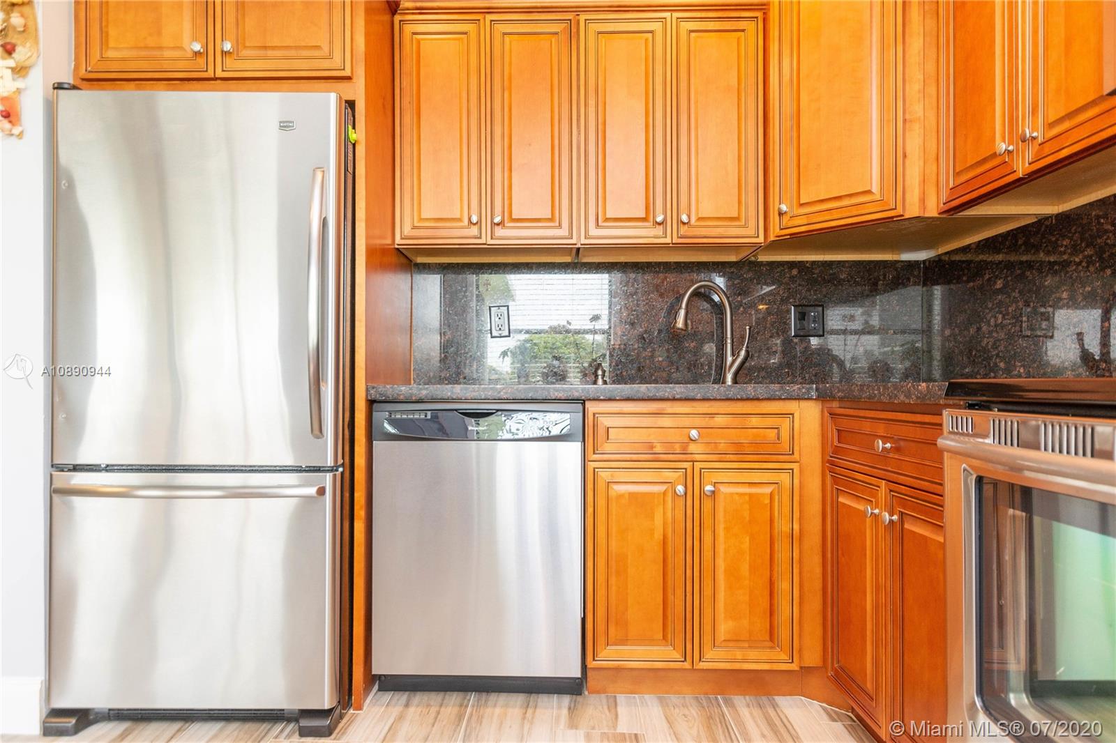 9254 Gettysburg Road Boca Raton, FL 33434 - Photo 16 of 49 a kitchen with stainless steel appliances granite countertop a refrigerator and a stove with wooden floor