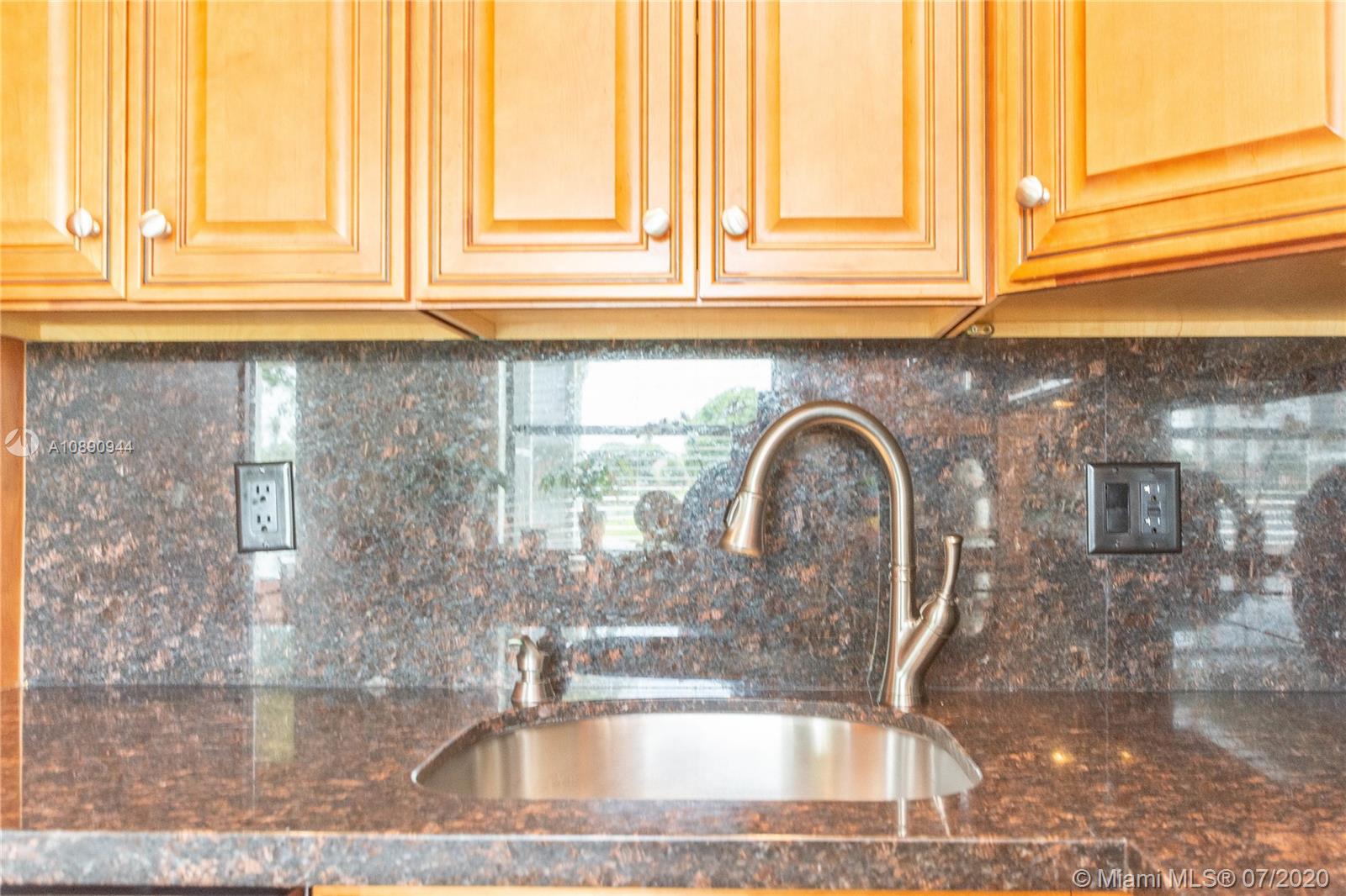 9254 Gettysburg Road Boca Raton, FL 33434 - Photo 17 of 49 a close view of a kitchen sink with granite countertop a coffee maker next to a window