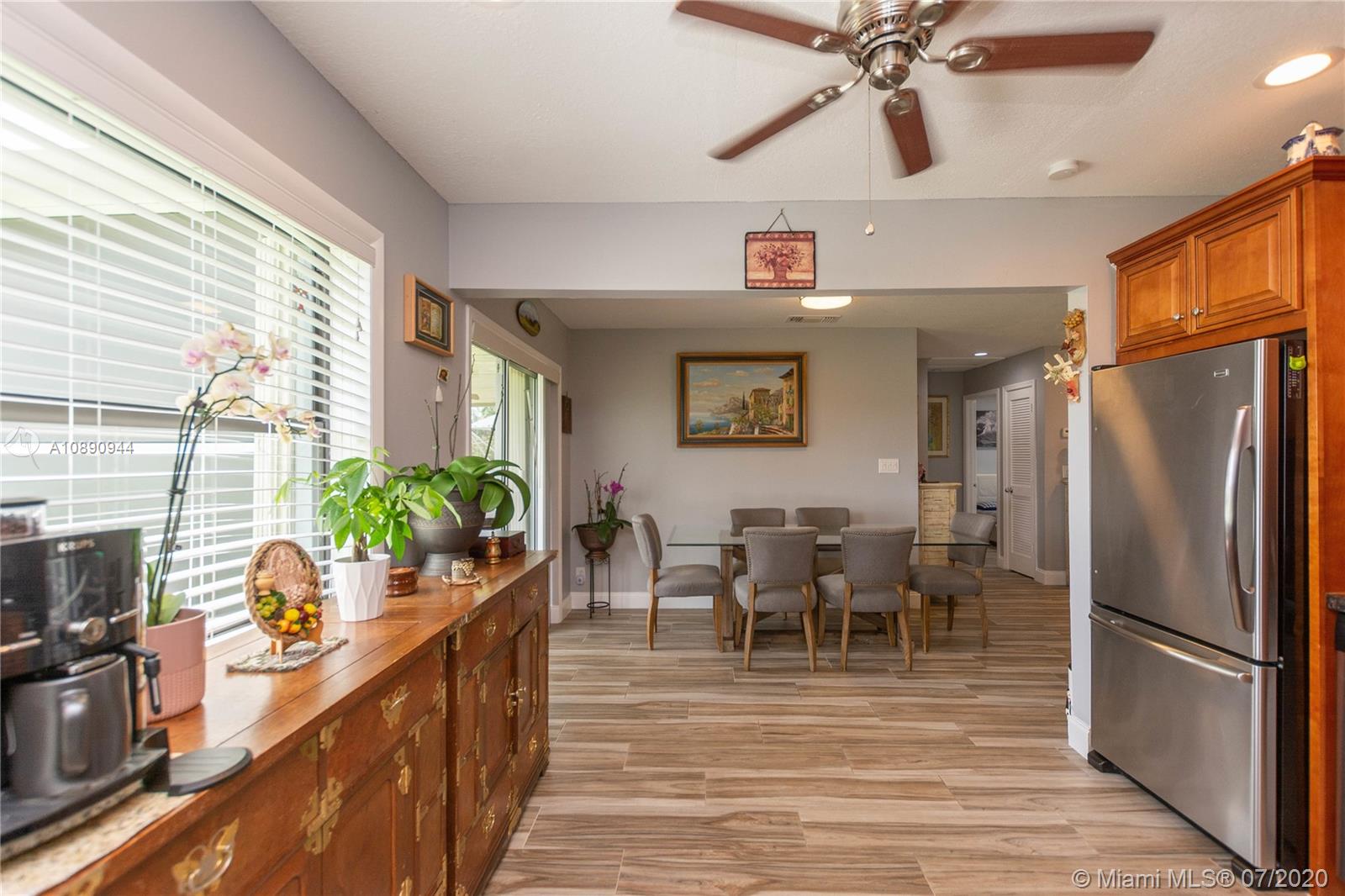 9254 Gettysburg Road Boca Raton, FL 33434 - Photo 21 of 49 a kitchen with stainless steel appliances granite countertop a refrigerator dining table and chairs