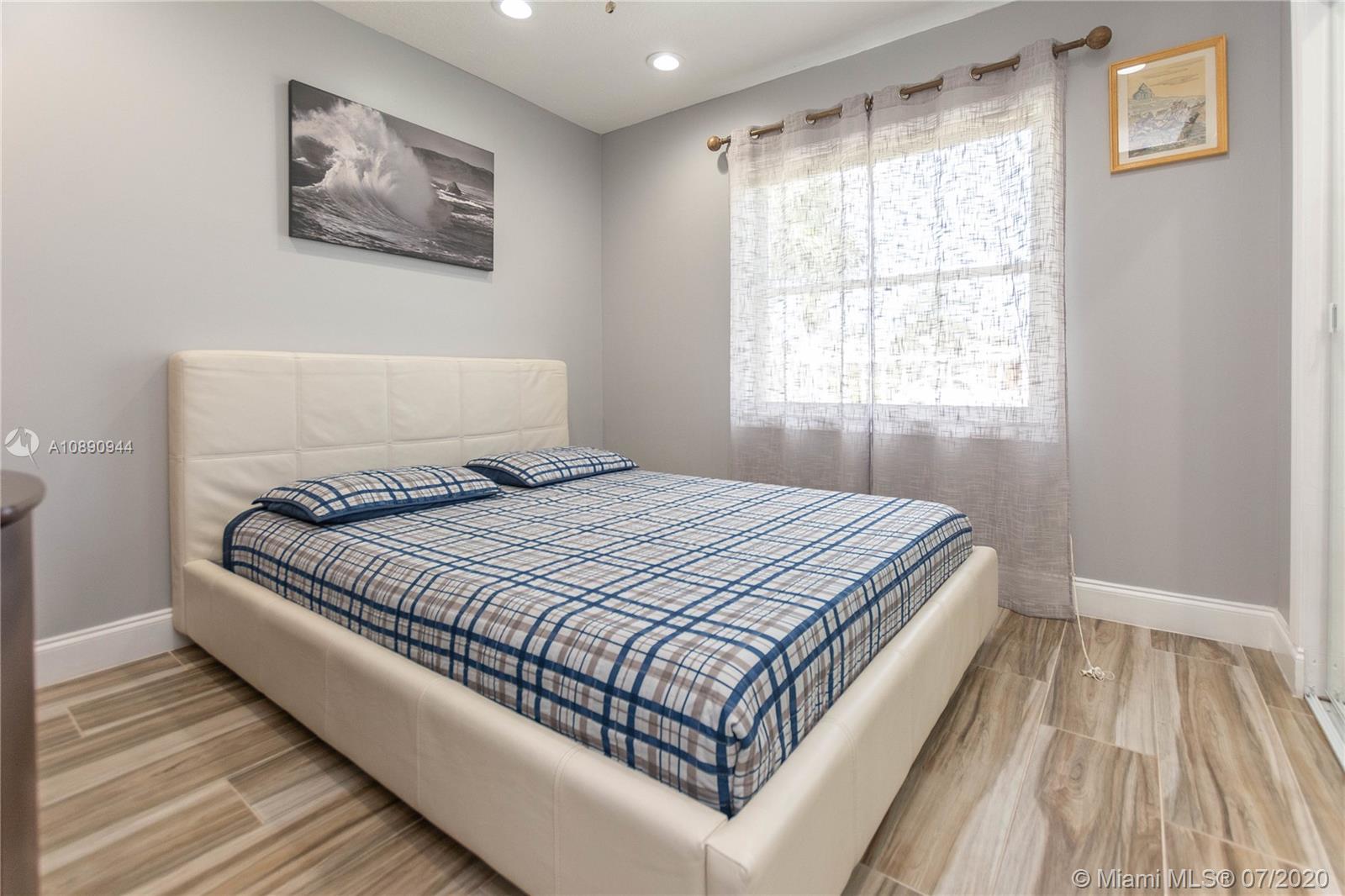 9254 Gettysburg Road Boca Raton, FL 33434 - Photo 26 of 49 a large bed sitting in a bedroom next to a window