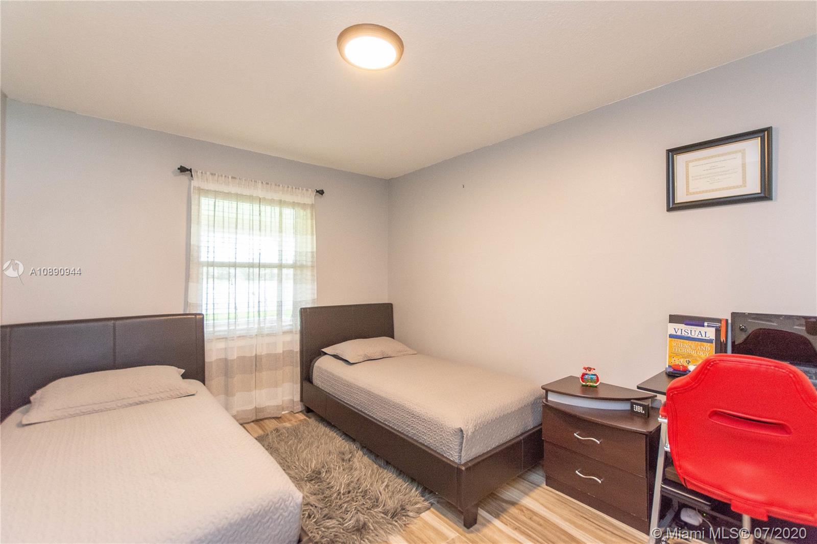9254 Gettysburg Road Boca Raton, FL 33434 - Photo 29 of 49 a bedroom with a bed and window
