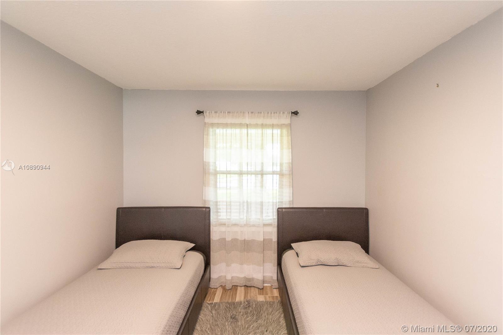 9254 Gettysburg Road Boca Raton, FL 33434 - Photo 30 of 49 a hotel room with two beds and a couch