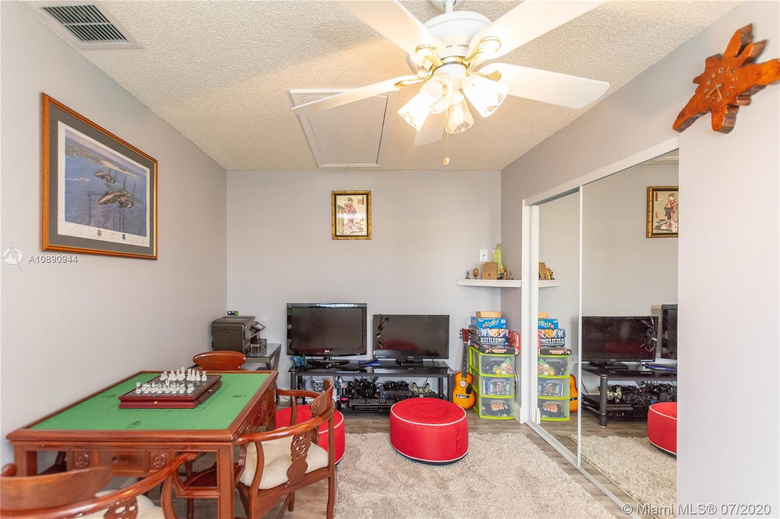 9254 Gettysburg Road Boca Raton, FL 33434 - Photo 35 of 49 a view of a dining room with furniture and a flat screen tv