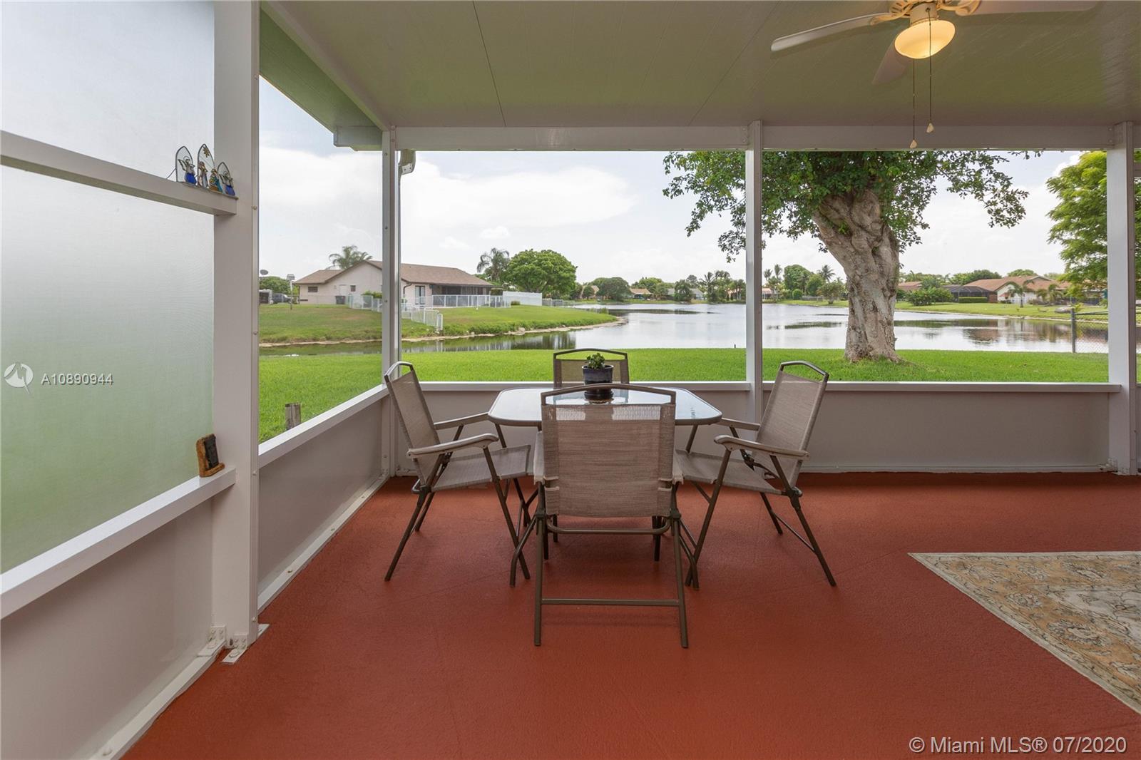 9254 Gettysburg Road Boca Raton, FL 33434 - Photo 40 of 49 a view of chairs and table in patio with a yard