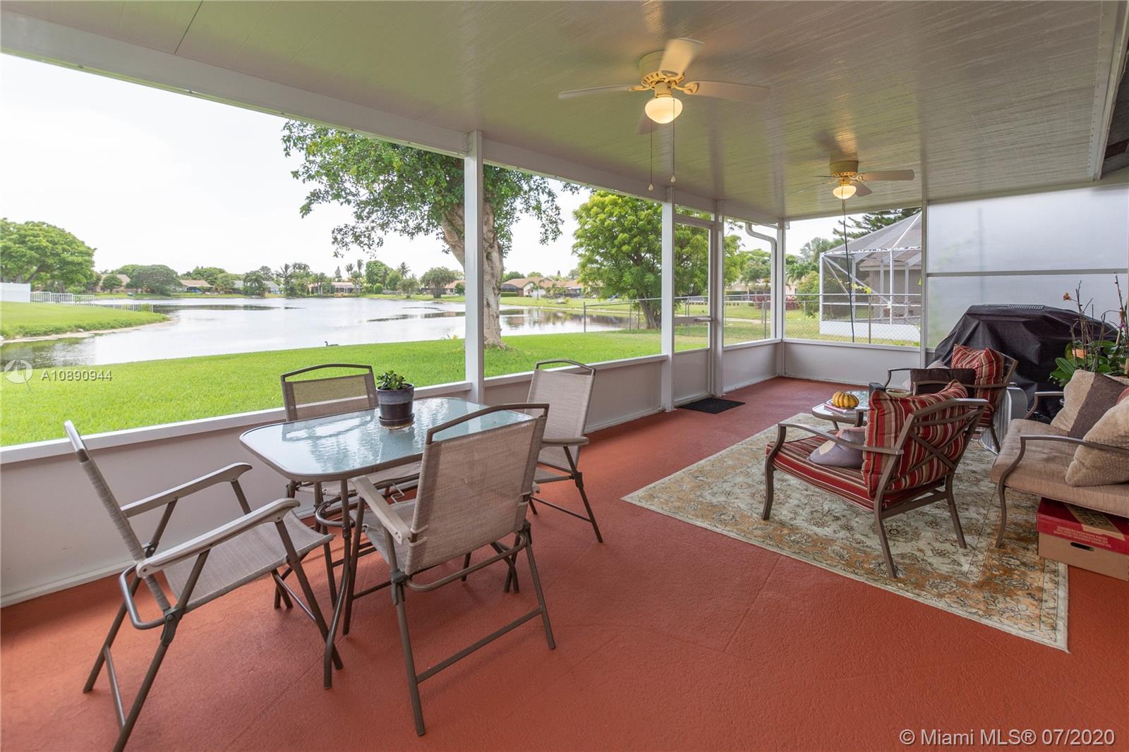 9254 Gettysburg Road Boca Raton, FL 33434 - Photo 41 of 49 a view of a patio with furniture and a yard