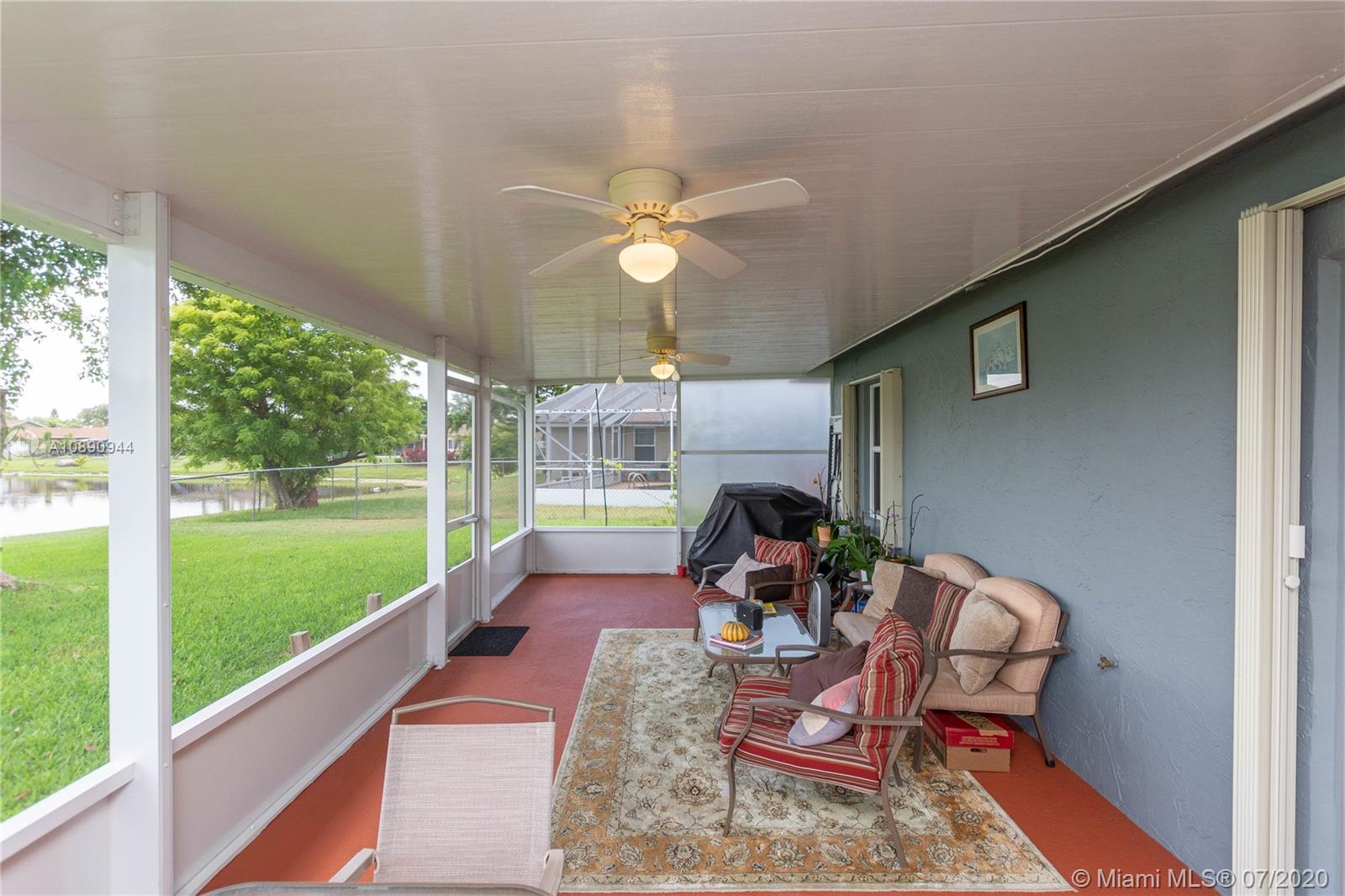 9254 Gettysburg Road Boca Raton, FL 33434 - Photo 42 of 49 a view of a porch with furniture and a yard