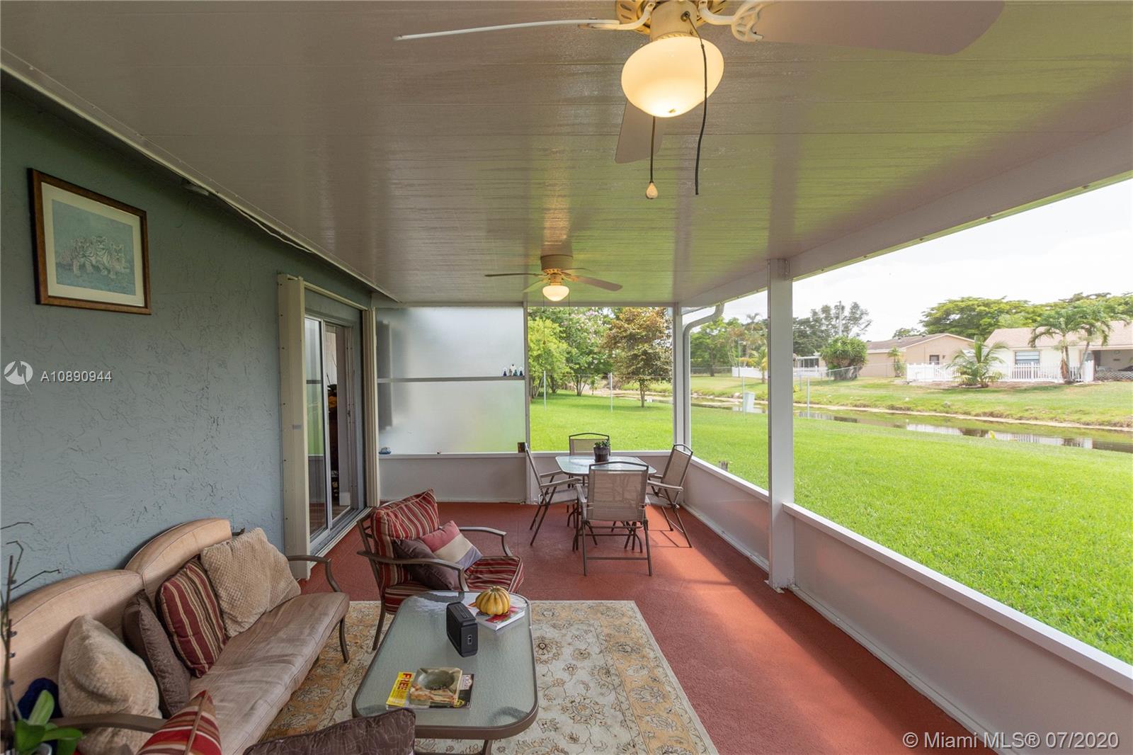 9254 Gettysburg Road Boca Raton, FL 33434 - Photo 44 of 49 a living room with furniture and a floor to ceiling window