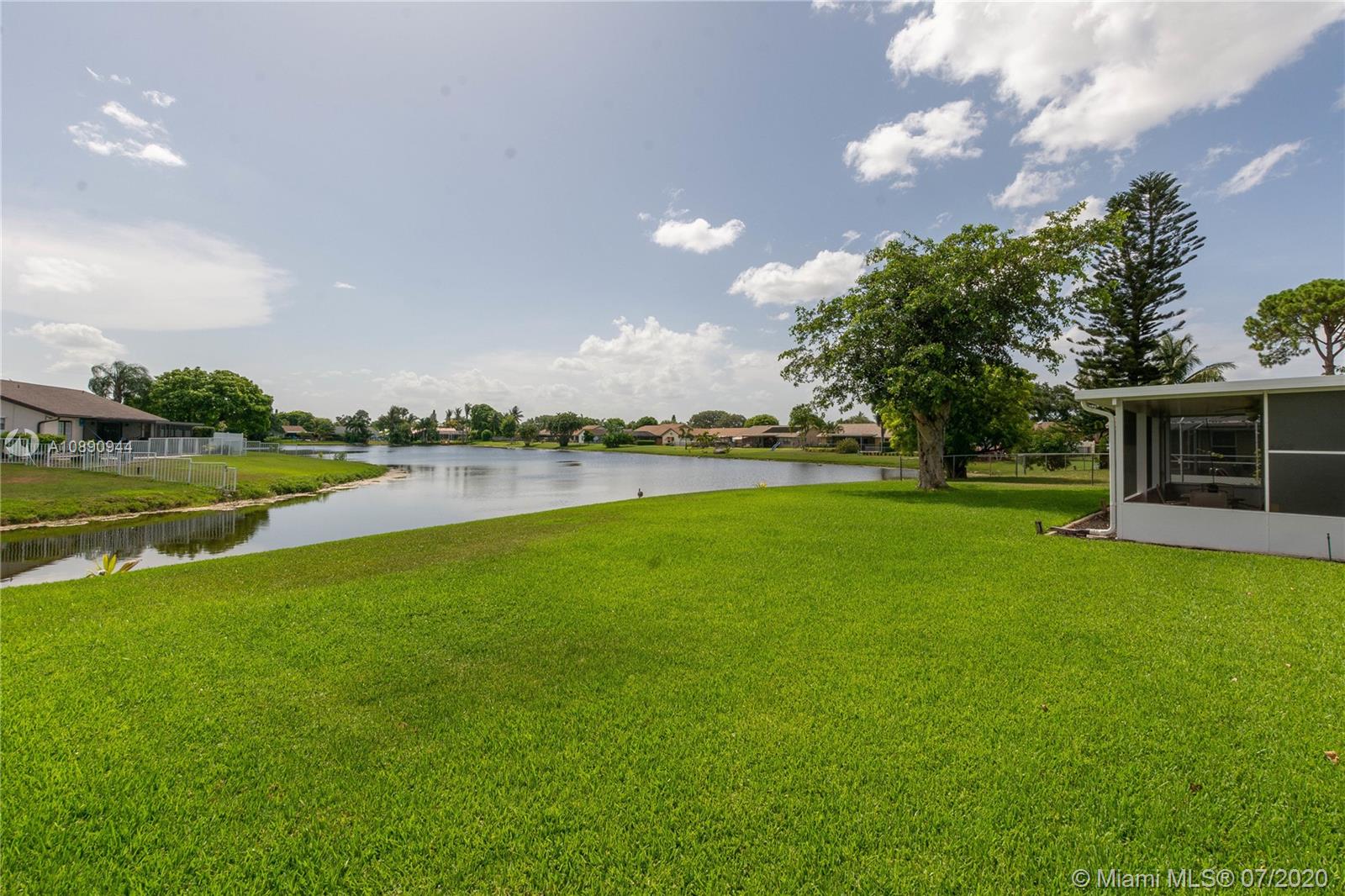 9254 Gettysburg Road Boca Raton, FL 33434 - Photo 45 of 49 a view of a house with a big yard and potted plants