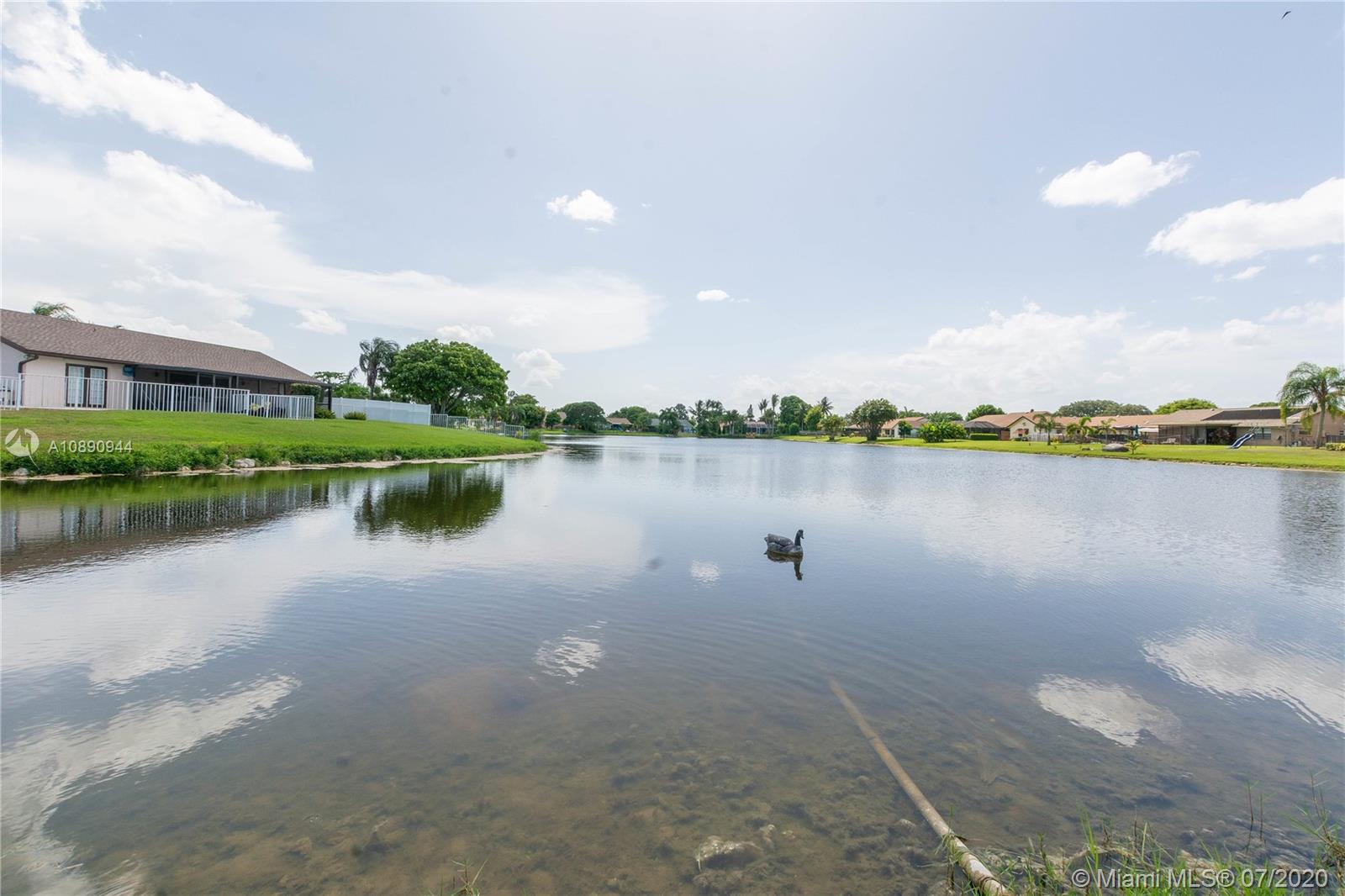 9254 Gettysburg Road Boca Raton, FL 33434 - Photo 48 of 49 a view of a lake with houses in the back