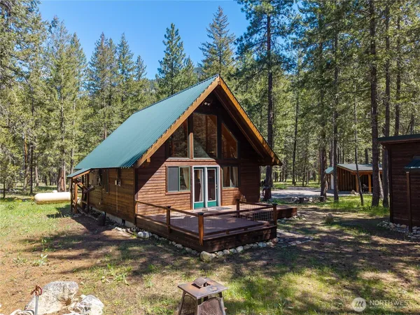 a view of a small house in the forest