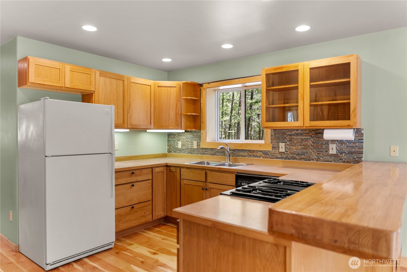651 Lost River Road Mazama, WA 98833 - Photo 14 of 38 a kitchen with a sink a stove and a refrigerator
