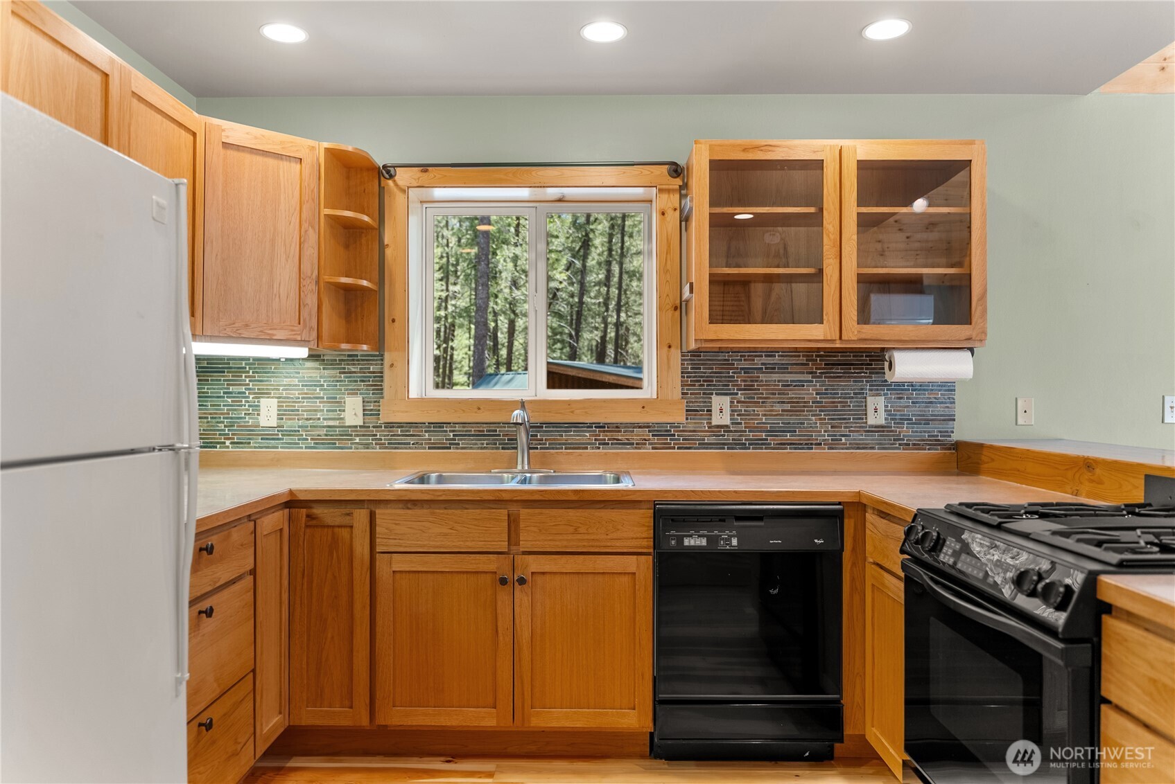 651 Lost River Road Mazama, WA 98833 - Photo 15 of 38 a kitchen with stainless steel appliances granite countertop a stove and a sink