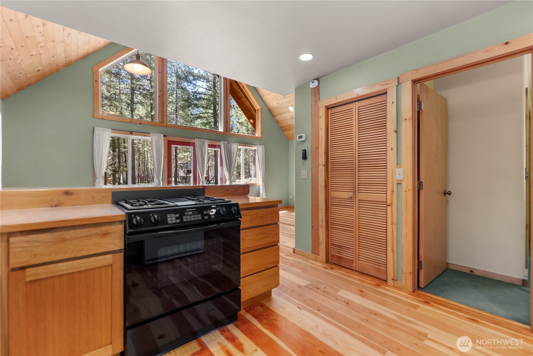 651 Lost River Road Mazama, WA 98833 - Photo 16 of 38 a kitchen with stainless steel appliances granite countertop a stove and a refrigerator