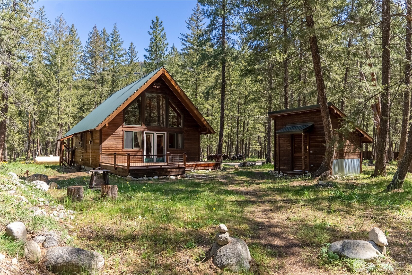 651 Lost River Road Mazama, WA 98833 - Photo 25 of 38 a front view of a house with garden