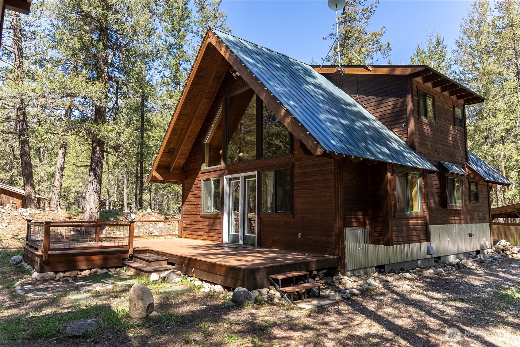651 Lost River Road Mazama, WA 98833 - Photo 3 of 38 a view of a house with wooden fence