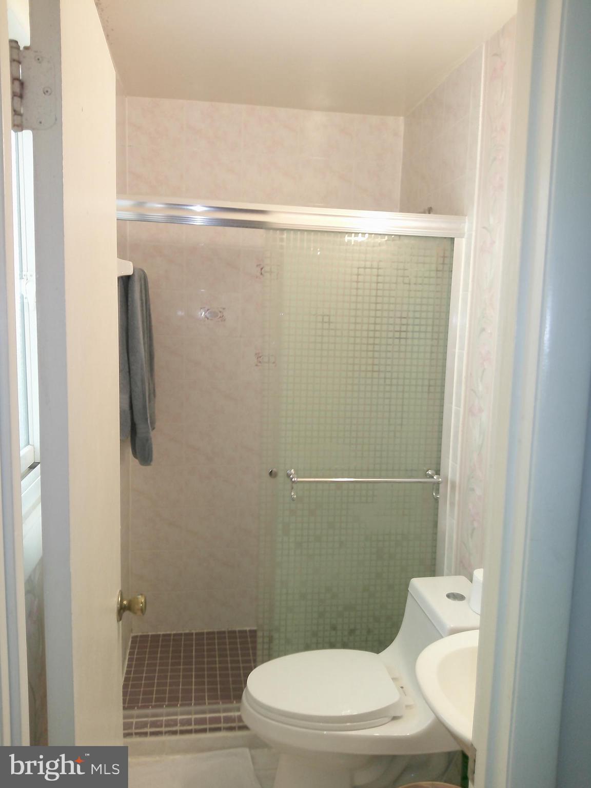 12300 Downer Drive Silver Spring, MD 20906 - Photo 14 of 53 a white toilet sitting next to a bathroom sink