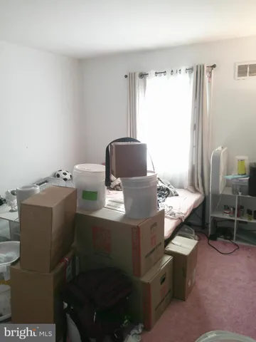 a view of a room that has a couch and a table in it