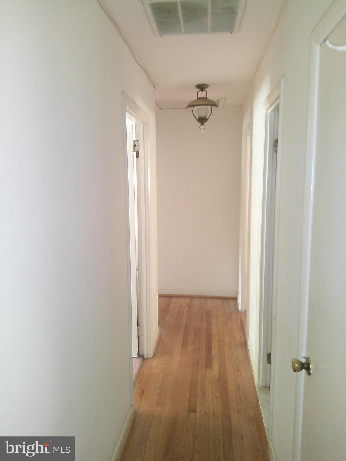 12300 Downer Drive Silver Spring, MD 20906 - Photo 19 of 53 a view of a hallway with wooden floor and a glass door
