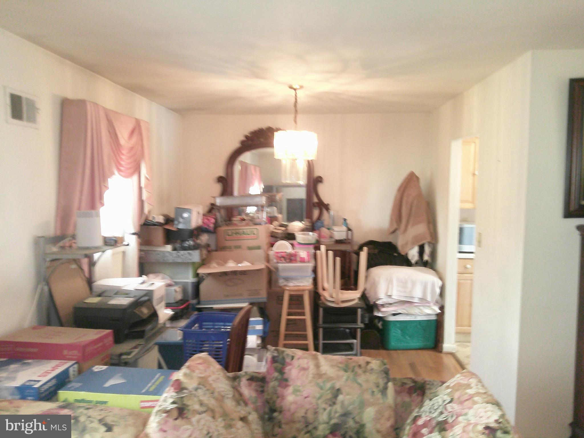12300 Downer Drive Silver Spring, MD 20906 - Photo 22 of 53 a living room with lots of furniture and a chandelier