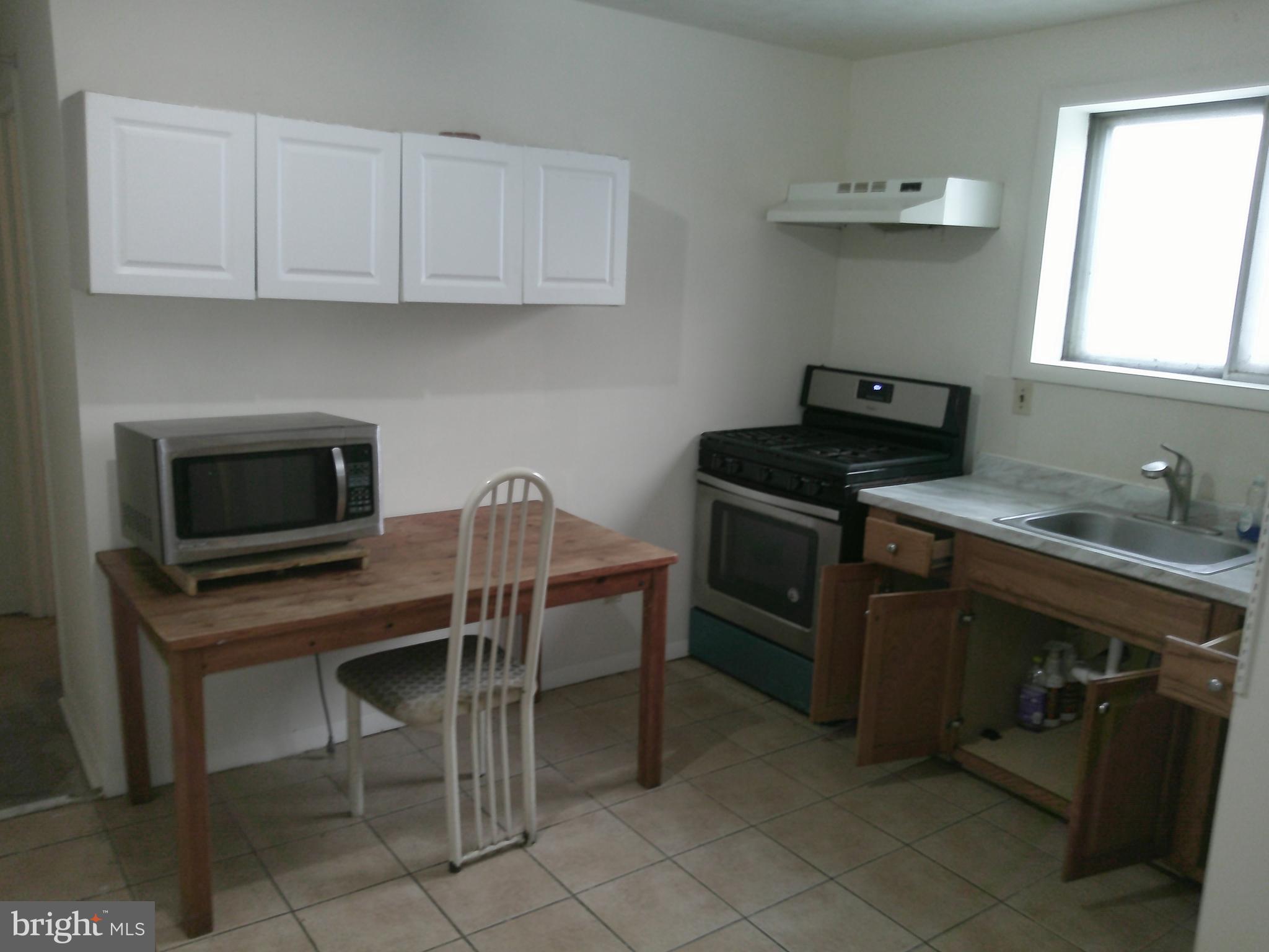12300 Downer Drive Silver Spring, MD 20906 - Photo 46 of 53 a kitchen with stainless steel appliances a stove a sink and white cabinets