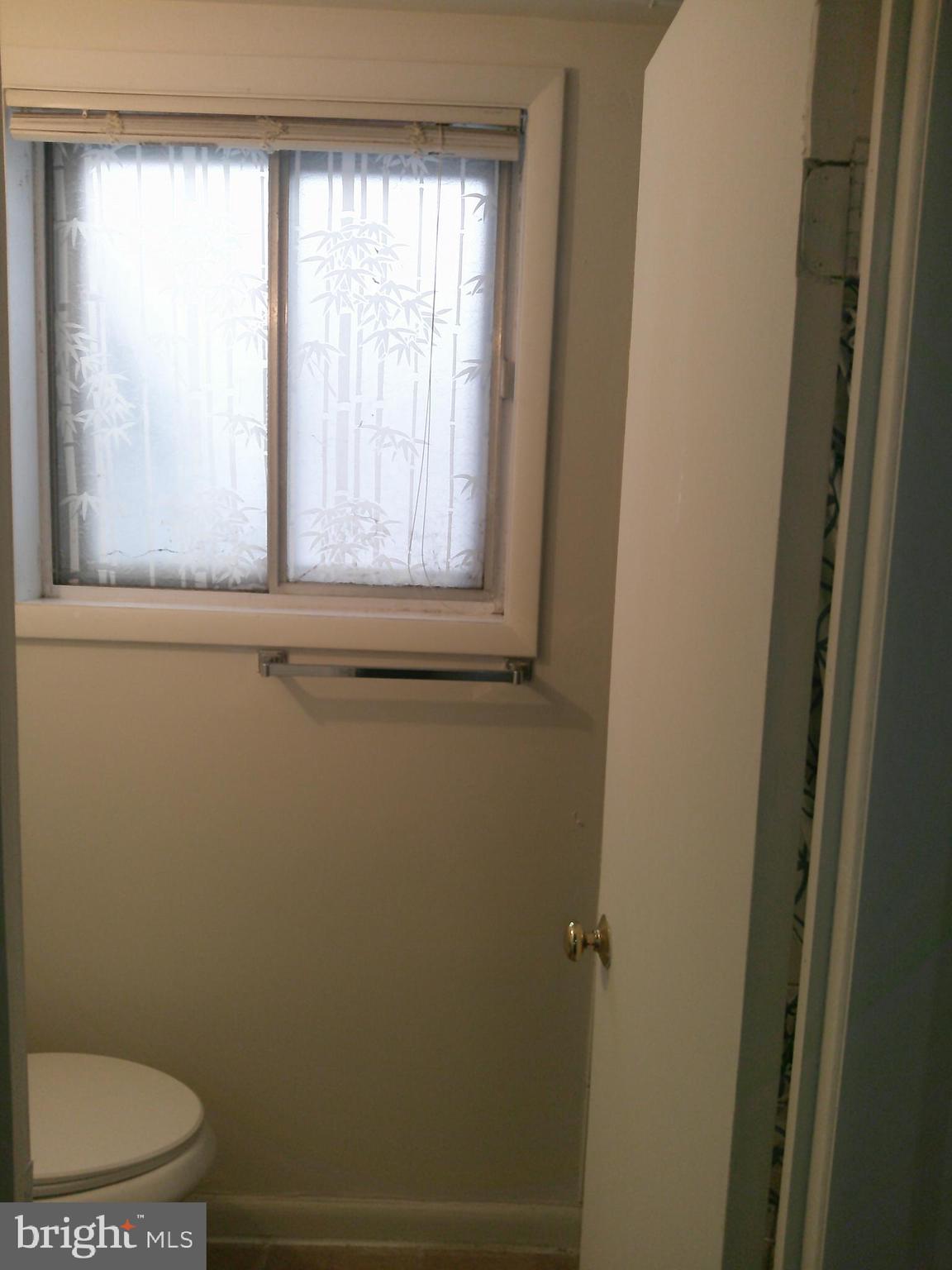 12300 Downer Drive Silver Spring, MD 20906 - Photo 50 of 53 a bathroom with a toilet a sink and a window