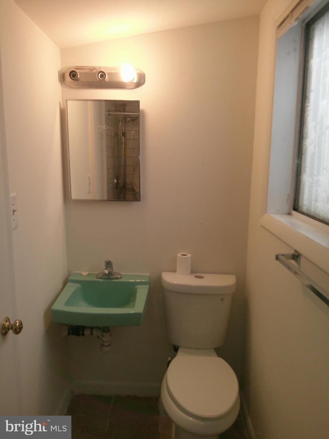 12300 Downer Drive Silver Spring, MD 20906 - Photo 52 of 53 a bathroom with a toilet a sink and mirror