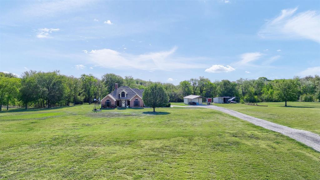 688 Harris Road Howe, TX 75459 - Photo 11 of 12 a backyard of a house with table and chairs