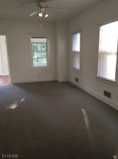 an empty room with a empty space and windows