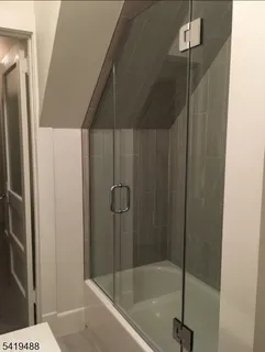 a bathroom with a shower and a sink