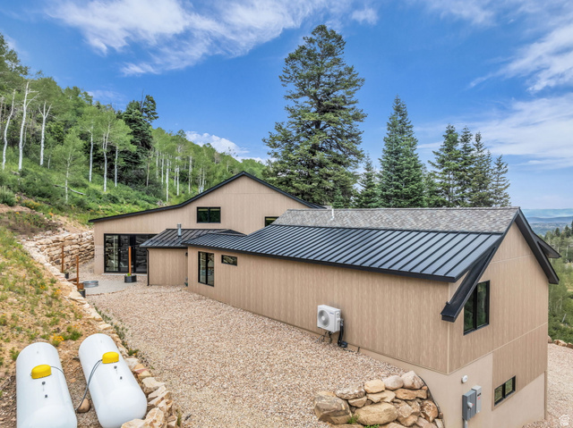 1766 West Tollgate Cyn Road Coalville, UT 84017 - Photo 52 of 59 Exterior featuring light-toned vertical siding and a combination of shingle and standing seam metal roofing