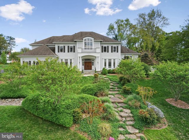 a large white house with a white fence