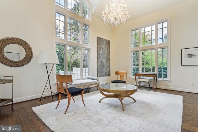 a living room with furniture a fireplace and a large window