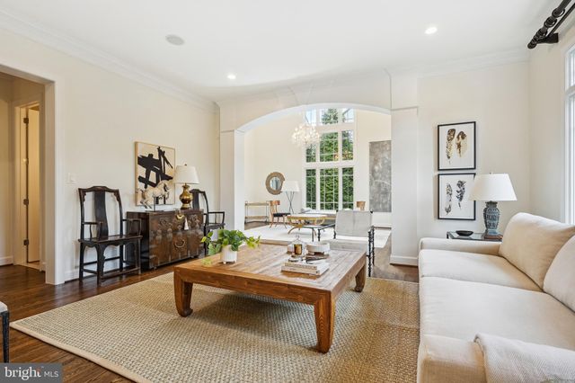 a living room with furniture a rug and a large window