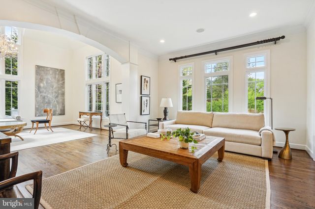 a living room with furniture and large windows