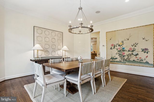 a view of a dining room with furniture wooden floor and a chandelier