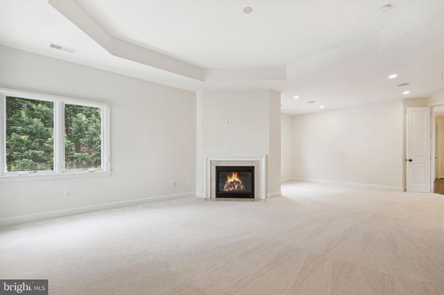 a white bath tub sitting in a bathroom next to a window