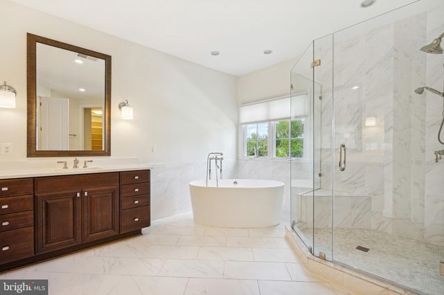 a spacious bathroom with a shower sink and mirror
